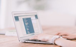 woman typing on laptop LMS