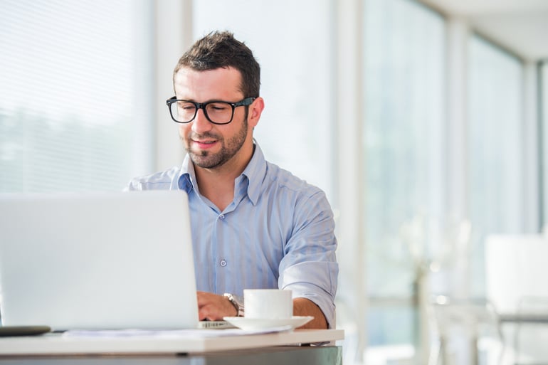 Businessman at work with laptop in his office