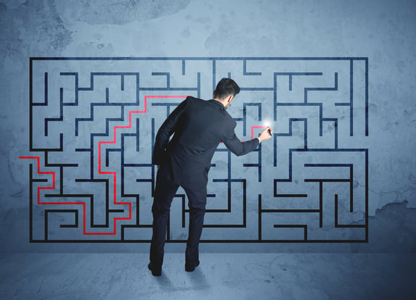 Businessman finding the solution of a maze-1
