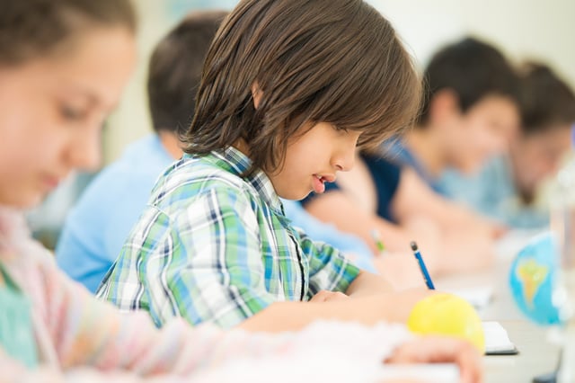 Cheerful kids learning in school classroom