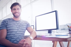 Close up view of a casual businessman smiling at the camera