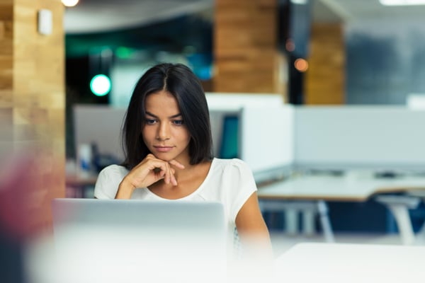 Portrait of a serious businesswoman using laptop in office-1