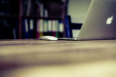 laptop sitting on a table corporate lms demo