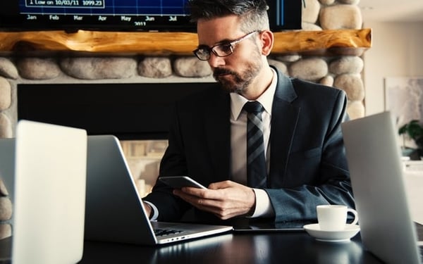 professional-looking man on laptop and phone training 2