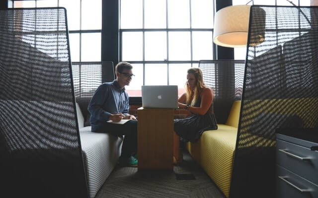 two employee working together on one laptop LMS onboarding.jpg